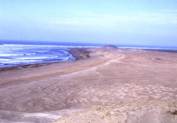 Coastal desert site of Chimor with large looted Pre-Inca cemetary in forground